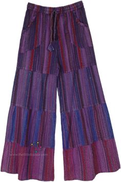 A pair of purple-toned cotton wide-leg pants. With a drawstring waist, these pants ensure absolute comfort - the pattern is stitched in four progressive patches and they increase in girth towards the hem making them wide leg on the final layer. #tlb #SplitSkirtsPants #WideLegCulottes #Patchwork #Striped #BohemianPants Purple Wide Leg Pants With Elastic Waistband, Purple Cotton Wide Leg Pants With Pockets, Purple Cotton Pants With Elastic Waistband, Purple Cotton Pants With Pockets, Purple Wide Leg Cotton Pants With Pockets, Purple Full Length Wide Leg Pants With Pockets, Multicolor Cotton Wide Leg Pants With Pockets, Purple Cotton Wide Leg Pants, Purple Cotton Wide Leg Pants For Spring