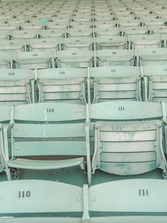 rows of empty green seats in a stadium