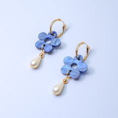 The Daisy Pearl Drops are elegant floral earrings that add a touch of class and polish to any outfit. Perfect for a fancy affair (wedding! date night!) or any occasion when you want to impress and glimmer! Hand-made in studio using beautiful marbled acrylic and glass pearls.  The drops hang from 18mm, 14 karat, gold-filled hoops and are removable so you can wear the hoops on their own—two earrings in one, perfect for travel! Uses 14 karat gold-filled hoops which are tarnish resistant and hypoall Blue Charm, Hoop Charms, Gold Filled Hoops, Bottom Jeans, Blue Daisy, Pink Marble, Lavender Color, Wedding Date, Bell Bottom