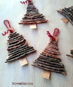 four small christmas trees made out of sticks