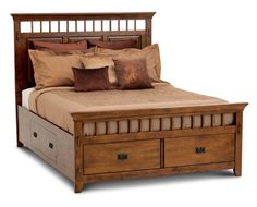 a bed with two drawers underneath it and pillows on top of the bedspread