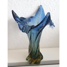 a glass vase sitting on top of a table