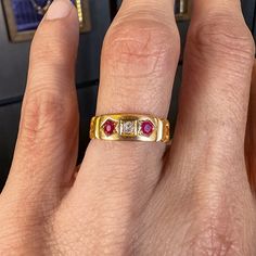 Measuring approximately 6.6mm. wide, centering an Old Mine cut diamond weighing approx. 0.50ct., flanked by two square step cut rubies measuring approx. 3.5x 3.5mm., fashioned in 18k yellow gold. Stamped "18" and with maker's mark. Size 7 3/4. ______ At Doyle & Doyle, jewelry is as sustainable as it is beautiful. Our vintage and antique jewelry is innately ethical and conflict-free as it does not involve any new mining or negative environmental impact. We are proud that our in-house jewelry line Opal Diamond Ring, Diamond Signet Ring, Navy Velvet, Ruby Diamond Rings, Cameo Brooch, Ruby Diamond, Recycled Gold, Ruby Ring, Contemporary Jewelry