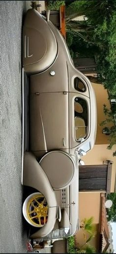 an old car is parked on the side of the road