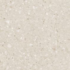 a close up view of a white marble textured surface with small speckles