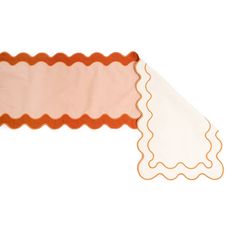 an orange and white scalloped window valance with ruffled edges on a white background