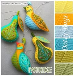 three colorful birds hanging from strings on a gray surface with color swatches in the background