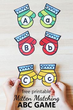 hands holding up matching letters and numbers to make a mitten matching game for kids