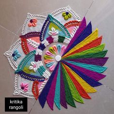 a colorful piece of art made out of felt on the floor with words that read, kittika rangoli