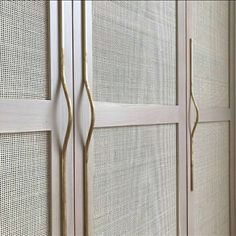 an image of a white closet with gold handles