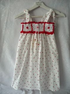 a white and red dress hanging on a hanger