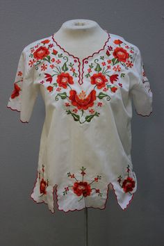 "Round neckline with scalloped edging that dips to a V Short sleeves with scalloped edging 2 side and 2 front alits Gorgeous floral embroidery throughout TAG/LABEL:  Sz 36 APPROXIMATE MEASUREMENTS (Measured Flat): Bust 41\" Sleeve Length 8\" Armhole 14\" Shoulder to Shoulder 17\" Length 23\" CONDITION:  I found no issues." Short Sleeve Cotton Tops With Scalloped Edges, Cotton Tops With Scalloped Edges And Short Sleeves, Cotton Short Sleeve Tops With Scalloped Edges, Fitted Short Sleeve Embroidered Top, Fitted Short Sleeve Top With Embroidered Hem, Spring Fitted Blouse With Embroidered Border, Fitted Blouse With Embroidered Border For Spring, White Scalloped Edges Short Sleeve Top, White Short Sleeve Tops With Scalloped Edges