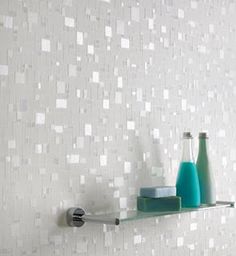 a bathroom shelf with two bottles and soap dispensers on it next to a tiled wall