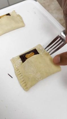 a person cutting up some food with a fork and knife