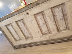 an old wooden cabinet sitting on top of a hard wood floor next to a wall