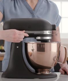 a person using a mixer on a counter