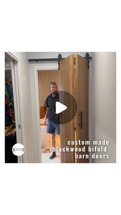 a man standing in front of a door with the words custom made blackwood hollow barn doors