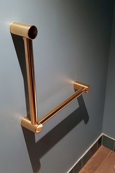 a gold toilet roll holder in a bathroom