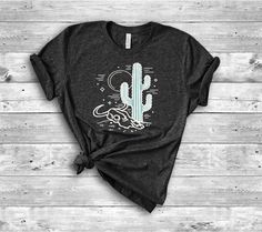 a women's t - shirt with a cactus and moon on it