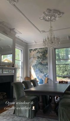 an elegant dining room with chandelier, fireplace and large painting on the wall