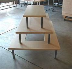 three wooden tables sitting on top of each other in a room with chairs and desks