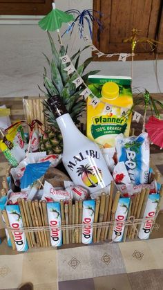 a basket filled with drinks and snacks on top of a table