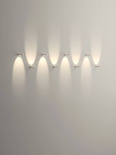 a group of lights that are next to each other on a wall in a room