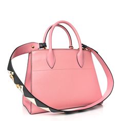 This is an authentic PRADA Saffiano City Calfskin Greche Paradigme Bag in Pink. This chic tote is crafted of stylish Saffiano cross grain leather in pink. The shoulder bag features an open top, two top zipper pockets, rolled leather top handles, an optional two-tone shoulder strap, and polished gold hardware. The top is open to a Prada logo jacquard interior with pockets. Prada Logo, Prada Saffiano, Open Top, Pink Bag, Leather Top, Gold Hardware, Zipper Pocket, Calf Skin, Two Tone