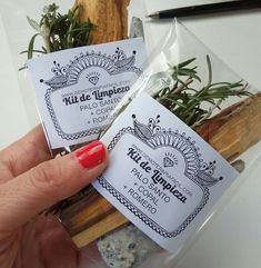 a person holding some kind of stick with herbs in it's wrapper on top of a table