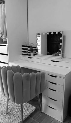 a white desk topped with a mirror and lots of drawers