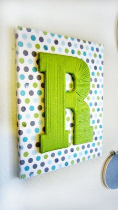 the letter p is made out of wood and has green paint on it, along with other items