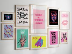 a bunch of posters are hanging on the wall in front of a white wall with pink, blue and green