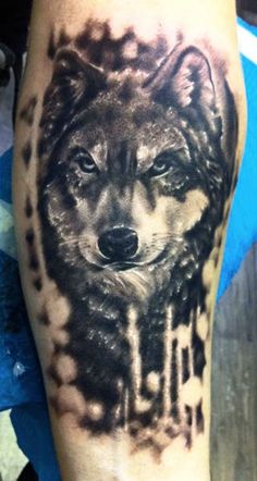 a black and white tattoo of a wolf