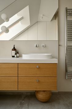 a bathroom with a sink, mirror and towel rack in it's center area