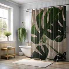 a bathroom with a shower curtain that has a large green leaf design on it, along with a bathtub and sink