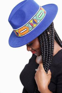 Embellished Women Fedora Hat with Ndebele beads available in various colours. Very stylish with an African touch. Festival Beaded Fedora With Flat Brim, Wide Brim Beaded Fedora For Festival, Beaded Wide Brim Fedora For Festivals, Festival Fedora Hat With Beads, One Size Multicolor Fedora Hat, Beaded Fedora Hat For Festivals, Festival Beaded Fedora Hat, Beaded Cap Hats For Festivals, Bohemian Blue Beaded Hat