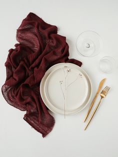 a white plate and some goldware on a table