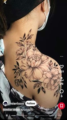 the back of a woman's shoulder with flowers on it