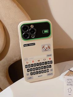 a cell phone that is sitting on top of a table next to a stuffed animal