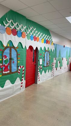 a classroom decorated for christmas with decorations on the front and side walls, along with santa's sleigh