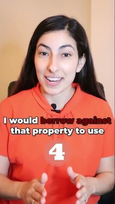 a woman in an orange shirt is holding up a button with the words i would borrow against that property to use