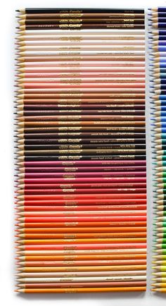 two rows of colored pencils sitting next to each other