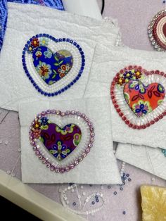 three heart shaped appliques are on the table