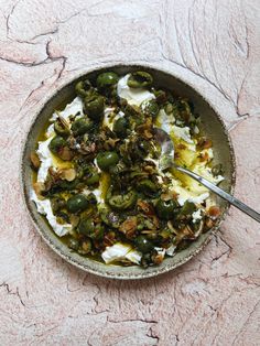 a bowl filled with food sitting on top of a table