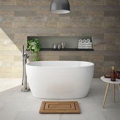 a white bath tub sitting in a bathroom next to a wooden shelf with bottles on it