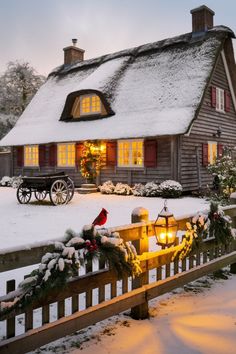 a christmas scene with a small cabin in the snow