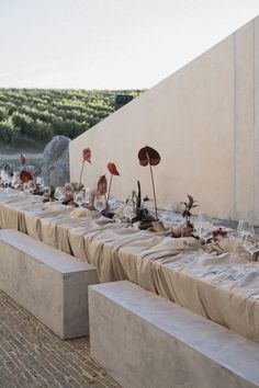 a long table is set up with flowers and candles