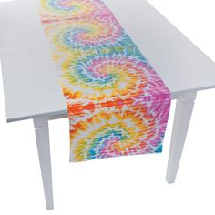 an image of a table runner with colorful swirls on the edge and white legs