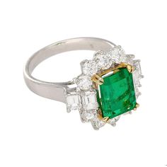 A magnificent natural emerald and diamond ring in 18k white and yellow gold. Set with a 2.55 carat Colombian emerald center stone. Complemented by 4 emerald-cut diamond side stones beside 10 round brilliant-cut diamonds. All of which are F-G color and VS clarity. This ring is unmistakably valuable to even the untrained eye.   A word about the center stone:   This emerald features superb color, transparency, and luster. It has a vibrant dark green color saturation that you only see in the finest Color Transparency, Emerald And Diamond Ring, Dark Green Color, Colombian Emeralds, Emerald Cut Diamond, Emerald Cut Diamonds, Natural Elements, Natural Emerald, Gold Set