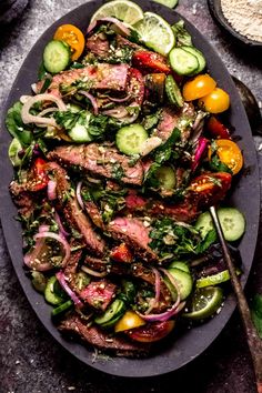 a plate filled with meat and vegetables on top of a table